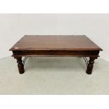 A RUSTIC HARDWOOD COFFEE TABLE WITH IRONCRAFT DETAIL - W 110CM. D 60CM. H 41CM.