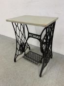 AN ORNATE CAST IRON SINGER TREADLE SEWING MACHINE BASE NOW FASHIONED AS A TABLE, W 56CM, D 41CM.