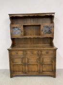 A GOOD QUALITY REPRODUCTION OAK DRESSER - W 137CM. D 44CM. H 183CM.