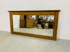 A LARGE WAXED WOOD OVERMANTEL MIRROR WITH BEVELLED PLATE GLASS 190.5CM X 96CM.