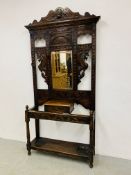 A HEAVILY CARVED HALL STAND WITH CENTRAL MIRROR AND GLOVE BOX - 104CM X 34CM X 126CM.