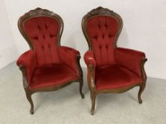 A PAIR OF REPRODUCTION CRIMSON VELOUR UPHOLSTERED BUTTON BACK ELBOW CHAIRS.