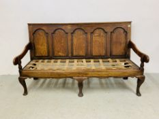 AN ANTIQUE OAK SETTLE WITH PANELLED BACK, NO CUSHIONS - W 185CM. D 75CM. H 107CM.