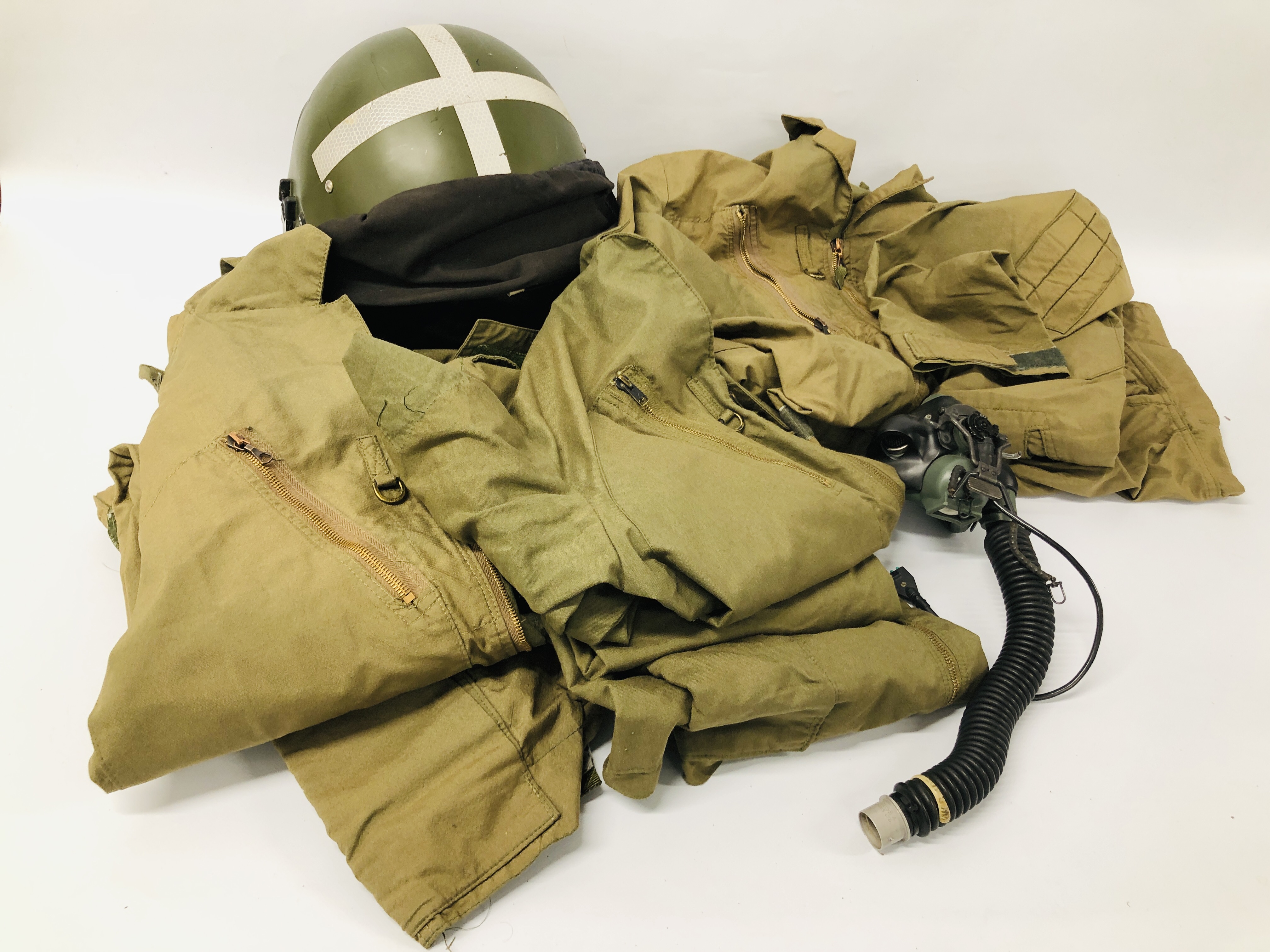 A FIGHTER PILOT'S HELMET ALONG WITH OXYGEN REGULATOR AND THREE SETS OF FLYING COVERALLS (FOR
