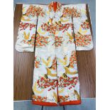 A JAPANESE WEDDING SILK KIMONO OF ORANGE AND GREEN DESIGN DEPICTING CRANES