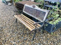 A HARDWOOD AND CAST IRON GARDEN BENCH LENGTH 127CM WITH ROSE DETAIL.