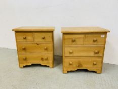 A PAIR OF WAXED PINE TWO OVER TWO DRAWER MINIATURE / BEDSIDE CHESTS EACH W 58CM. D 35CM. H 60CM.