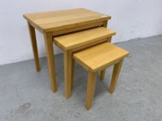 A SET OF THREE JULIAN BOWEN BEECHWOOD GRADUATED OCCASIONAL TABLES.