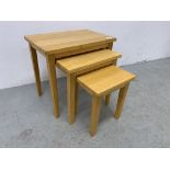 A SET OF THREE JULIAN BOWEN BEECHWOOD GRADUATED OCCASIONAL TABLES.