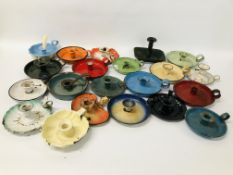 A COLLECTION OF 22 VARIOUS ENAMELLED CANDLE STICK HOLDERS OF VARIOUS COLOURS AND DESIGNS