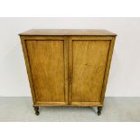 AN EARLY C19TH MAHOGANY TWO DOOR CUPBOARD WITH FITTED INTERIOR INCLUDING DRAWERS AND PIGEON HOLES