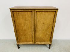 AN EARLY C19TH MAHOGANY TWO DOOR CUPBOARD WITH FITTED INTERIOR INCLUDING DRAWERS AND PIGEON HOLES