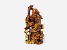 A JAPANESE CARVED HARDSTONE FIGURE OF AN ELDERLY MAN WITH A CHILD & A DEER,