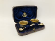 A PAIR OF SILVER GILT CIRCULAR SALTS WITH SPOONS IN CASE, LONDON 1869.