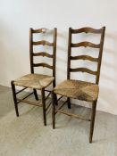 A PAIR OF ANTIQUE OAK LADDER BACK RUSH SEATED CHAIRS