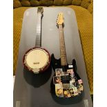 A BERRY BANJO AND AN ENCORE ELECTRIC LEAD GUITAR (HAVE BEEN USED AS WALL DECORATION) - SOLD AS SEEN