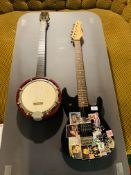 A BERRY BANJO AND AN ENCORE ELECTRIC LEAD GUITAR (HAVE BEEN USED AS WALL DECORATION) - SOLD AS SEEN