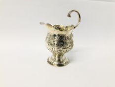 A MID C18TH CREAM JUG DECORATED WITH FLOWERS AND A VACANT CARTOUCHE AND OPEN SCROLLED HANDLE, H 10.