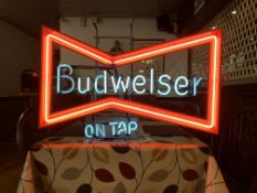 AN ILLUMINATED NEON "BUDWEISER ON TAP" ADVERTISING SIGN - W 73CM. H 50CM.