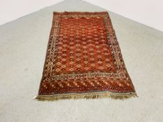 EARLY C20TH TURKOMAN RUG WITH STEPPED MOTIFS ON A RED FIELD - 195CM X 114CM.