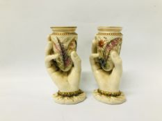 A PAIR OF WORCESTER VASES IN THE FORM OF A HAND SUPPORTING THEM, AFTER A DESIGN BY HANLEY C1900.