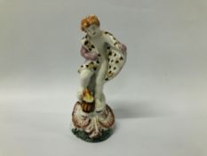 A PLYMOUTH FIGURE EMBLEMATIC OF WINTER, PAINTED IN A MUTED PALETTE - HEIGHT 14.5CM.