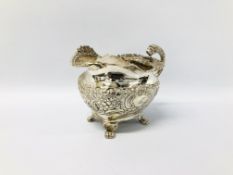 A GEORGE IV SILVER MILK JUG WITH LIONS HEAD HANDLE THE BODY DECORATED WITH FLOWERS AND CARTOUCHE ON