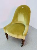 A VICTORIAN NURSING CHAIR COVERED IN GREEN DRALON