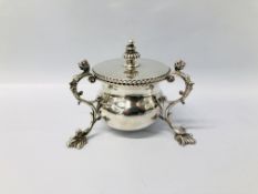 AN UNUSUAL SILVER MUSTARD POT OF A SQUAT BALUSTER BODY SUPPORTED BY SCROLLED HANDLES TERMINATING IN