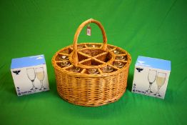 A WICKER CIRCULAR 12 GLASS BOTTLE HAMPER WITH 10 GLASSES AND 2 BOXES OF 6 AS NEW GLASSES
