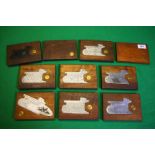 A COLLECTION OF 10 STEEL ENGRAVED SHOT GUN SIDE PLATES MOUNTED IN MAHOGANY,