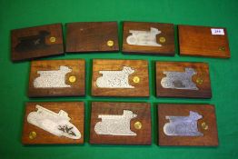 A COLLECTION OF 10 STEEL ENGRAVED SHOT GUN SIDE PLATES MOUNTED IN MAHOGANY,