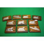 A COLLECTION OF 10 STEEL ENGRAVED SHOT GUN SIDE PLATES MOUNTED IN MAHOGANY,