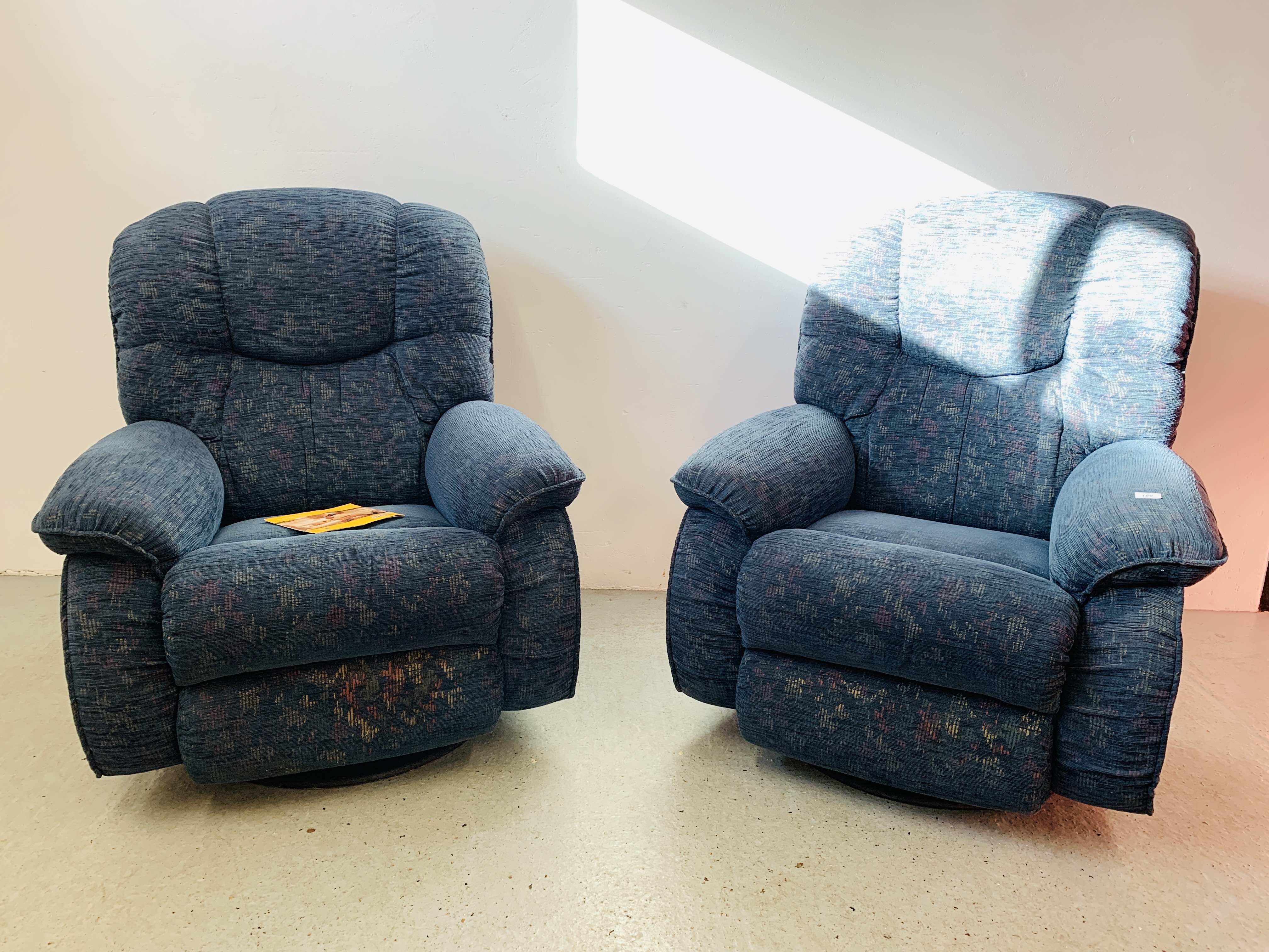 A PAIR OF LA-Z-BOY BLUE UPHOLSTERED SWIVEL RECLINER EASY CHAIRS