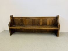 AN ANTIQUE OAK CHURCH PEW - W 215CM. D 49CM. H 89CM.