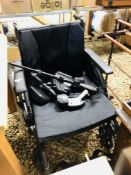 AN INVACARE FOLDING WHEEL CHAIR COMPLETE WITH TWO SETS OF LEG/FOOT RESTS