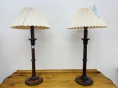 A PAIR OF SOLID OAK TURNED TABLE LAMPS WITH PLEATED SHADES