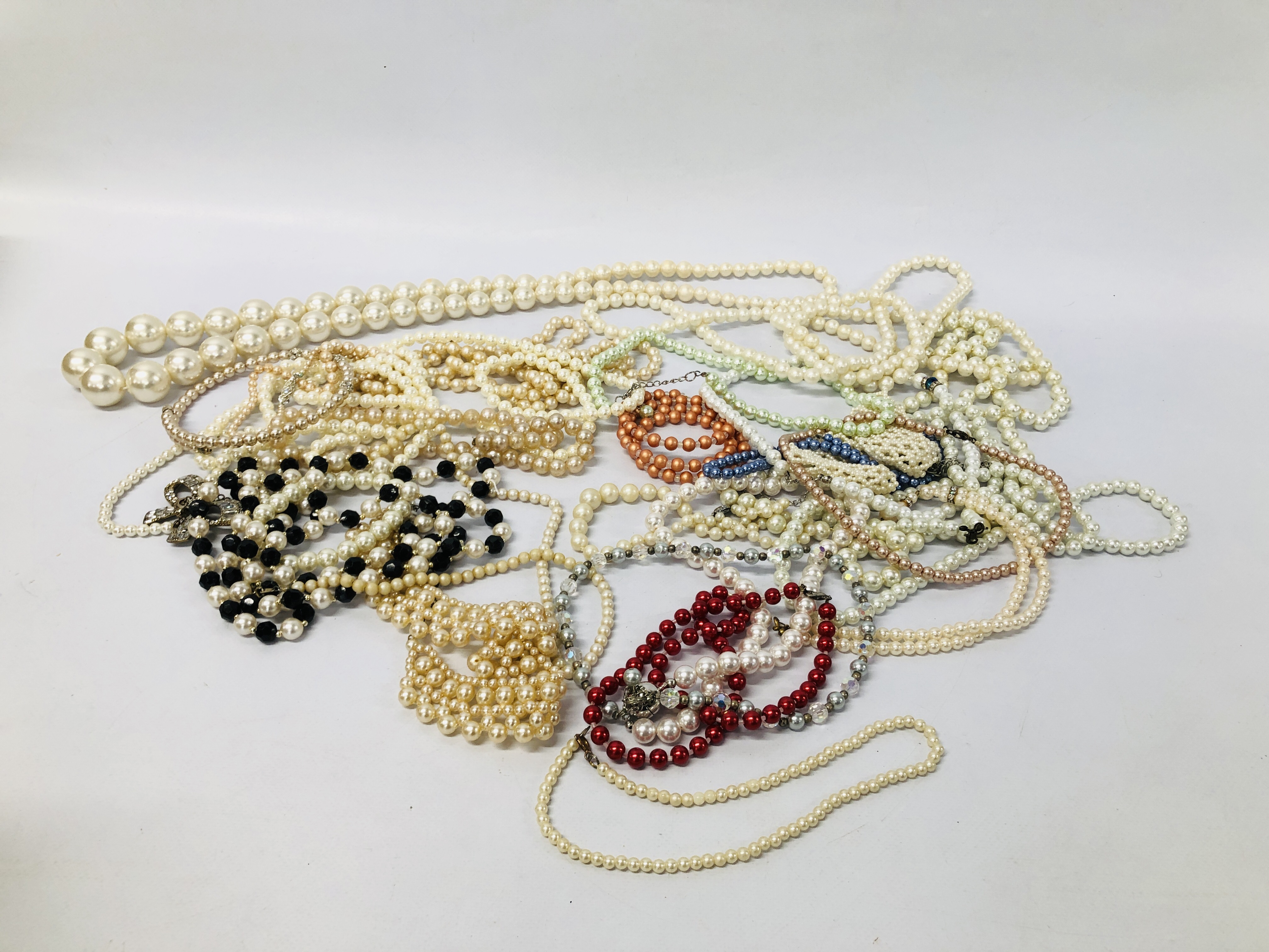 COLLECTION OF DESIGNER COSTUME SIMULATED PEARL NECKLACES.
