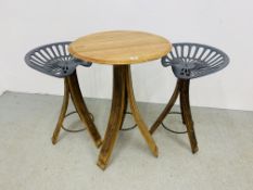 A RUSTIC CIRCULAR TOP OAK TABLE ON TRIPOD LEGS CONVERTED FROM WHISKY BARRELS ALONG WITH A PAIR OF