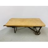 A CONVERTED ANTIQUE SACK BARROW COFFEE TABLE WITH HEAVY WAXED PINE TOP