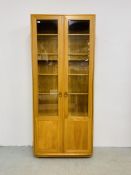 A MODERN ERCOL WINDSOR FULL HEIGHT PART GLAZED DISPLAY CABINET - W 92CM. D 32CM. H 214CM.