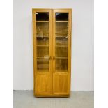 A MODERN ERCOL WINDSOR FULL HEIGHT PART GLAZED DISPLAY CABINET - W 92CM. D 32CM. H 214CM.