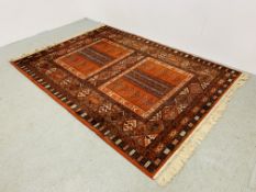 A LARGE RED PATTERN EASTERN RUG - W 170CM. L 240CM.