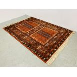 A LARGE RED PATTERN EASTERN RUG - W 170CM. L 240CM.