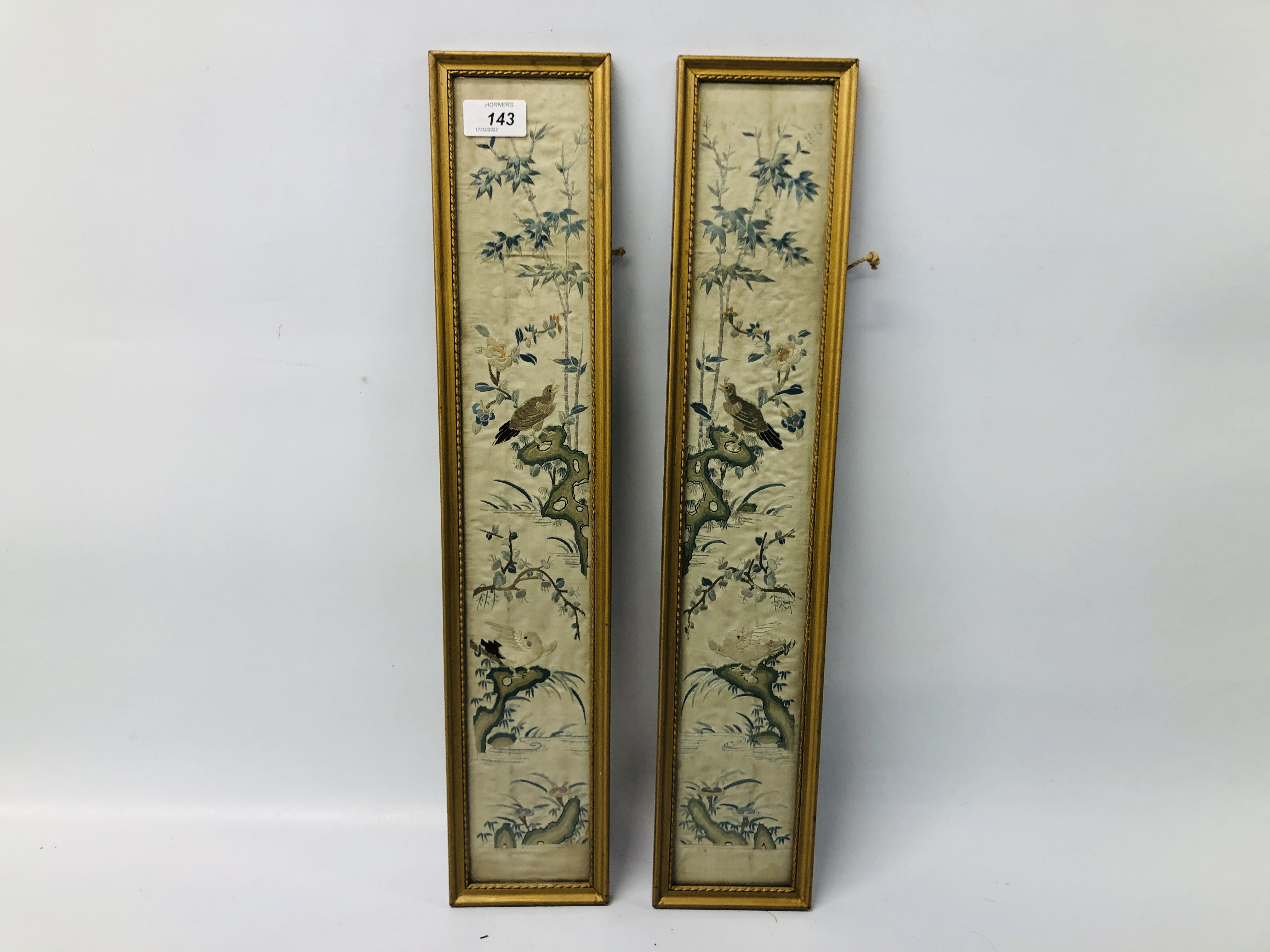 A PAIR OF C19TH CHINESE EMBROIDERIES OF BIRDS, ROCKS AND TREES EACH 54 X 9CM.