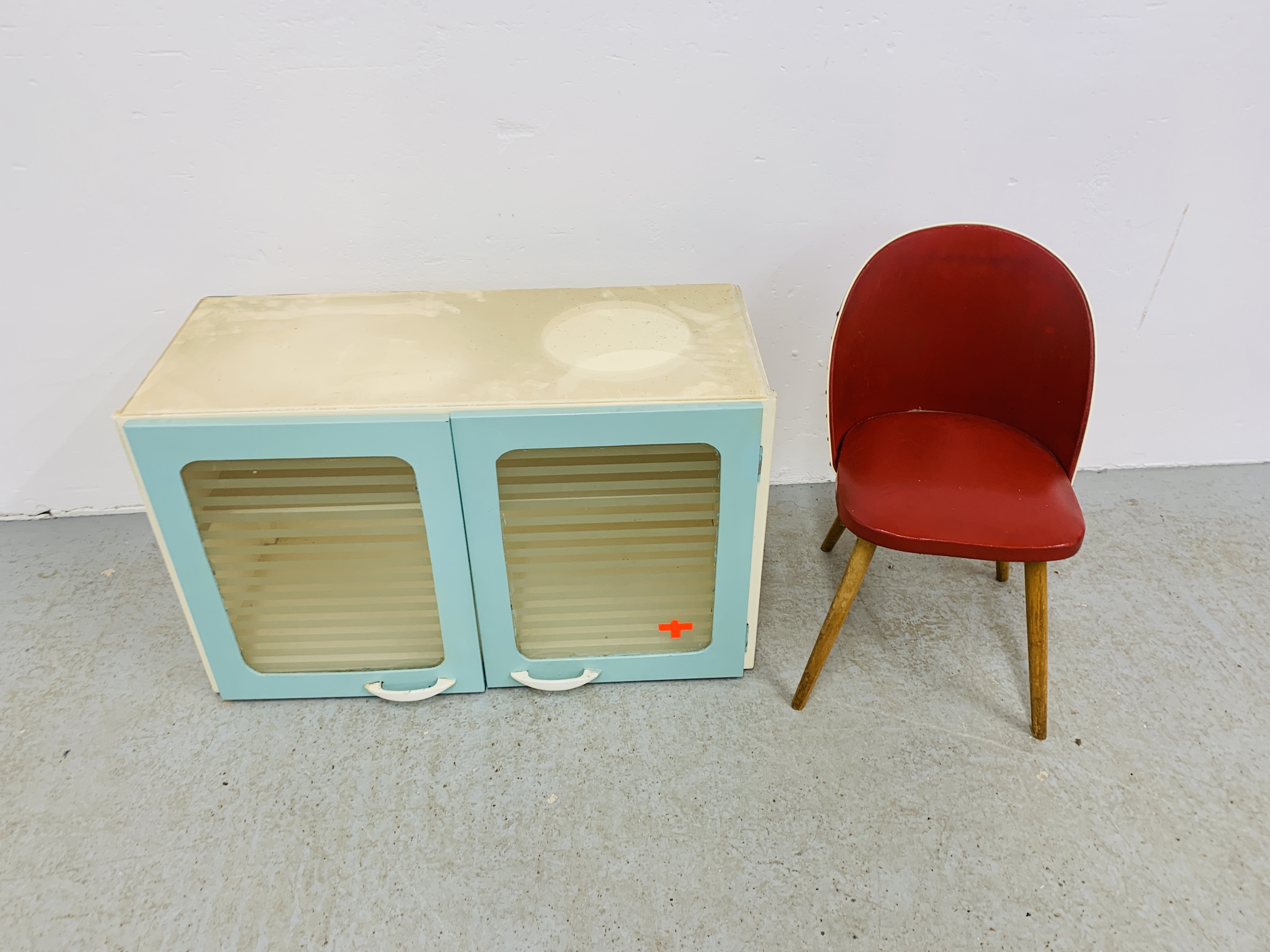 A 1940'S 2 DOOR KITCHEN CABINET ALONG WITH 1940'S RED CHILD'S CHAIR