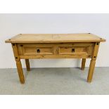 A MEXICAN PINE CORNER TWO DRAWER SIDE TABLE - W 127CM. D 48CM. H 74CM.