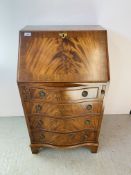 A REPRODUCTION MAHOGANY FIVE DRAEWR SERPENTINE FRONTED LADIES WRITING BUREAU WITH FITTED INTERIOR -