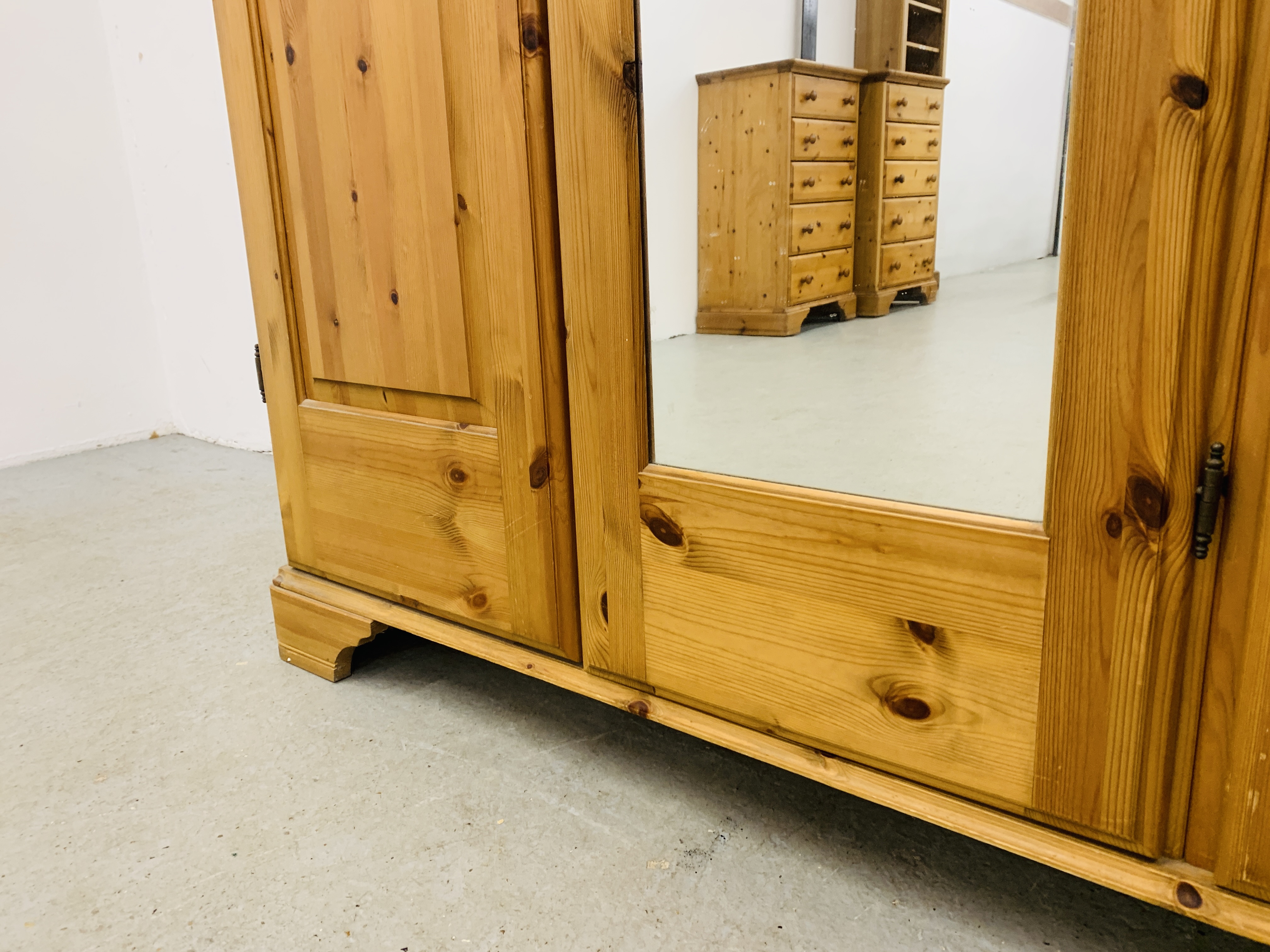 A GOOD QUALITY MODERN HONEY PINE TRIPLE WARDROBE WITH CENTRAL MIRRORED DRAWER MANUFACTURED BY - Image 7 of 12