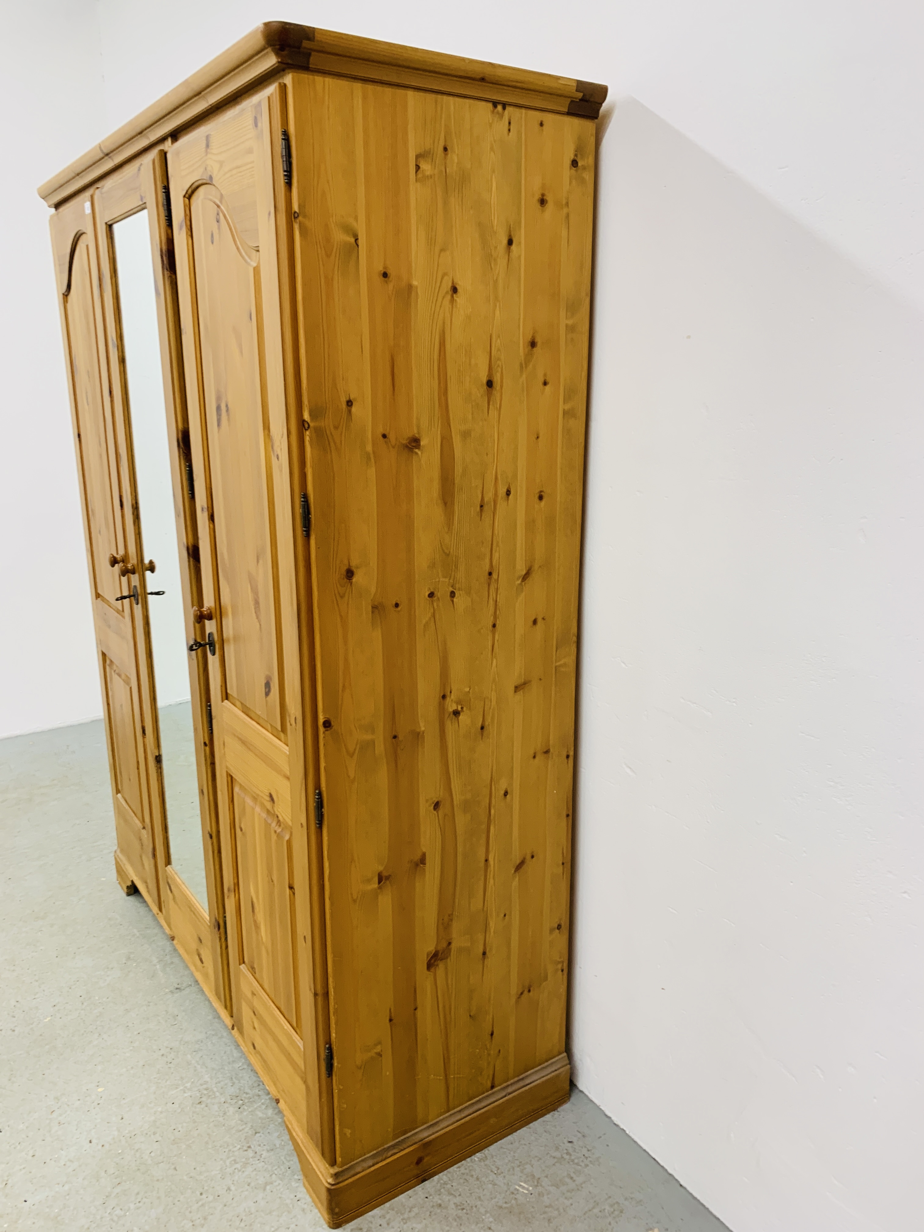 A GOOD QUALITY MODERN HONEY PINE TRIPLE WARDROBE WITH CENTRAL MIRRORED DRAWER MANUFACTURED BY - Image 8 of 12